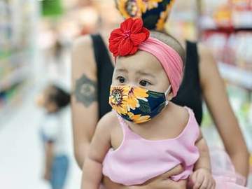 baby girl wearing mask in grocery store
